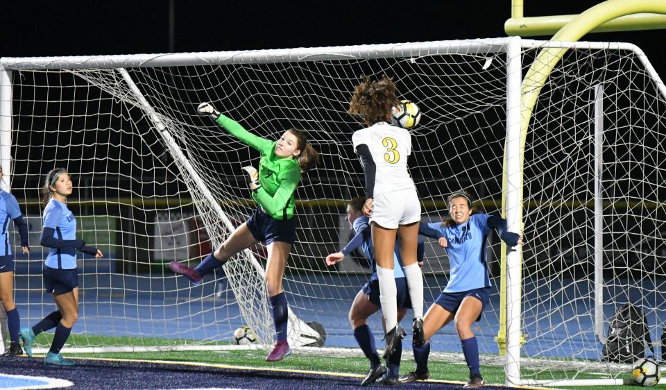 Gianna Foss heads in a corner kick in overtime to lift Moorpark to a 2-1 win over host Camarillo on Wednesday night and clinch the Coastal Canyon League title for the Musketeers.