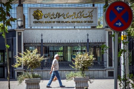 A man walks past the Central bank of Iran in Tehran