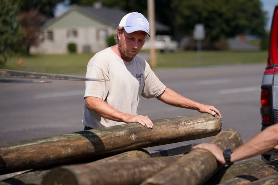 Mark Cook loads lumber onto a trailer, Tuesday, Oct. 3, 2023, in Bowling Green, Ky. Voters across Kentucky are making their choices ahead of the Nov. 7 gubernatorial showdown between Democratic Gov. Andy Beshear and his GOP challenger, Daniel Cameron. (AP Photo/George Walker IV)