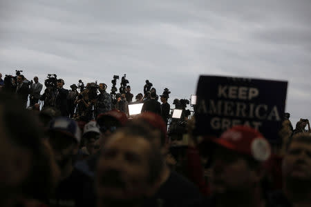 Members of the news media can be seen at the back of the crowd as supporters rally with U.S. President Donald Trump at Middle Georgia Regional Airport in Macon, Georgia, U.S. November 4, 2018. REUTERS/Jonathan Ernst