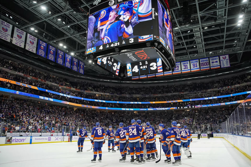 New York Islanders players celebrate after defeating the Columbus Blue Jackets during extra period of an NHL hockey game, Saturday, Nov. 12, 2022, in Elmont, N.Y. New York Islanders won 4-3. (AP Photo/Eduardo Munoz Alvarez)