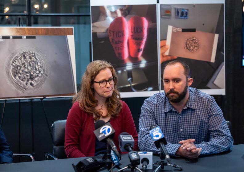 Santa Ana, CA - April 23: Brooke Berger speaks and Bennett Hardy listens during a press conference announcing a lawsuit against Newport Beach fertility clinic Ovation Fertility at Rob Marcereau law office in Santa Ana Tuesday, April 23, 2024. Brooke Berger and Bennett Hardy are one of nine couples that are suing Newport Beach fertility clinic Ovation Fertility alleging the clinic destroyed their embryos. (Allen J. Schaben / Los Angeles Times)