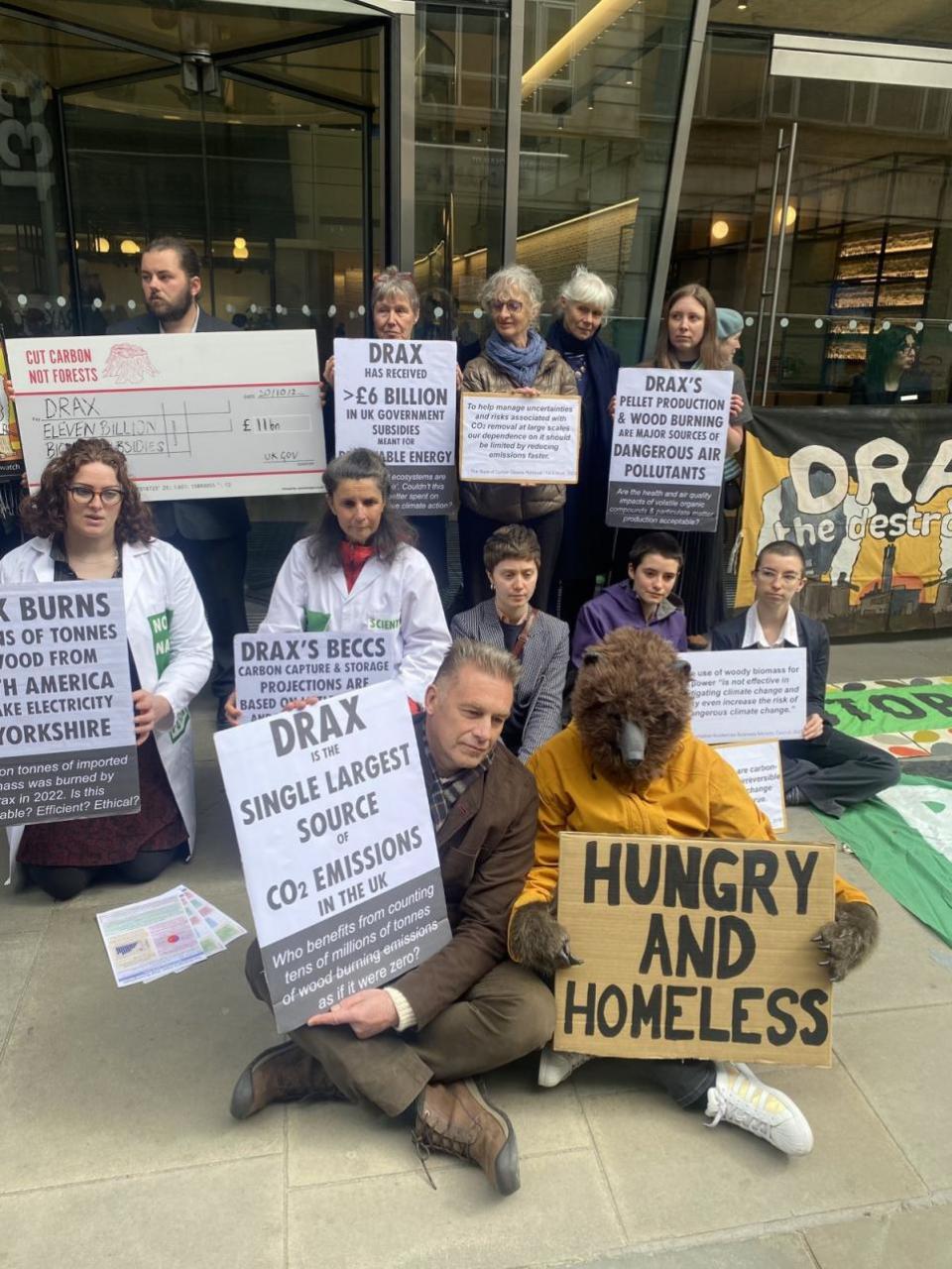 York Press: Handout photo issued by Axe Drax of broadcaster Chris Packham and members of the Axe Drax campaign group protesting outside the Drax AGM in the City of London on Thursday