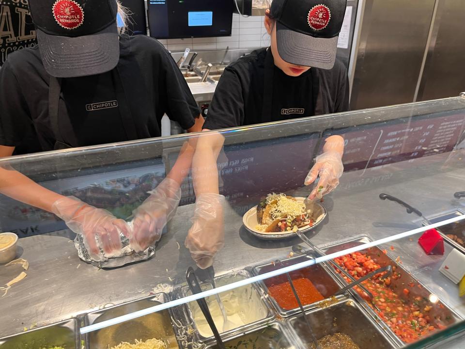 chipotle workers filling orders at a location in toronto