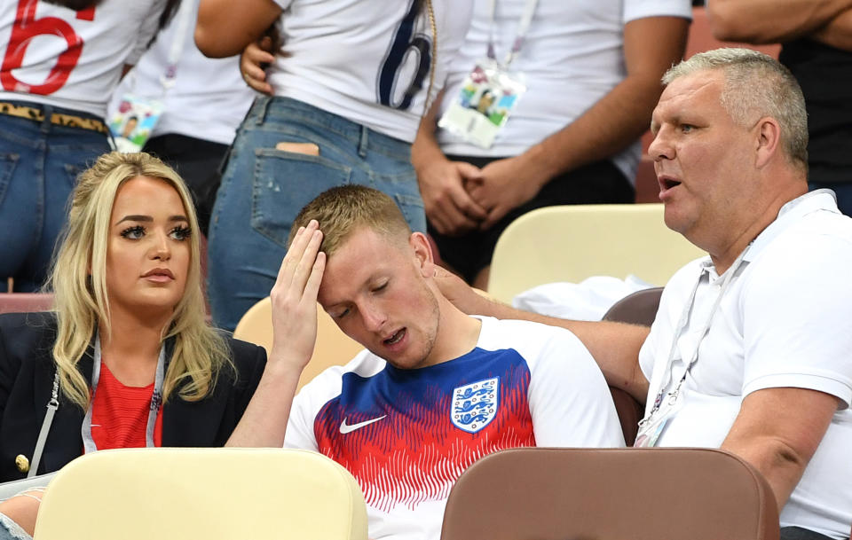 <p>Jordan Pickford holds his head in his hands. </p>