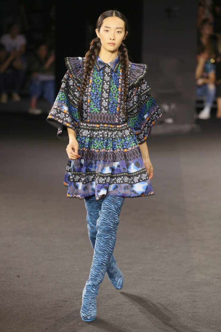A model walks in the Kenzo x H&M show wearing the thigh high zebra boots. Photo: Courtesy of H&M