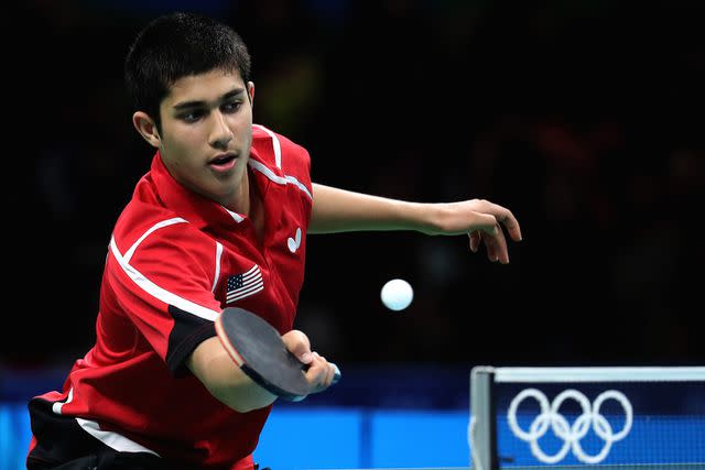 <p>Rob Carr/Getty</p> Kanak Jha of Team USA returns a shot to Kristian Karlsson of Sweden during the Men's Team Round 1 on Day 7 of the Rio 2016 Olympic Games at Riocentro - Pavilion 3 on August 12, 2016 in Rio de Janeiro, Brazil.