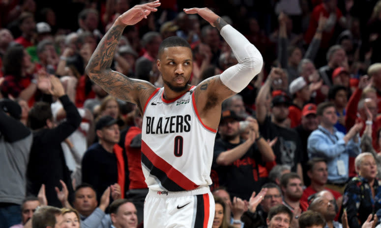 Damian Lillard celebrating after scoring.