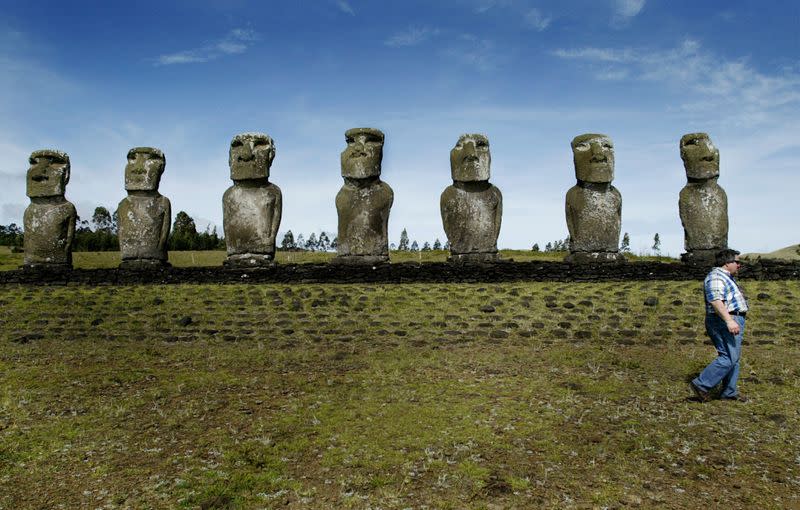 FILE PHOTO: TOURIST WALKS NEXT TO THE MOAI STATUES IN EASTER ISLAND.