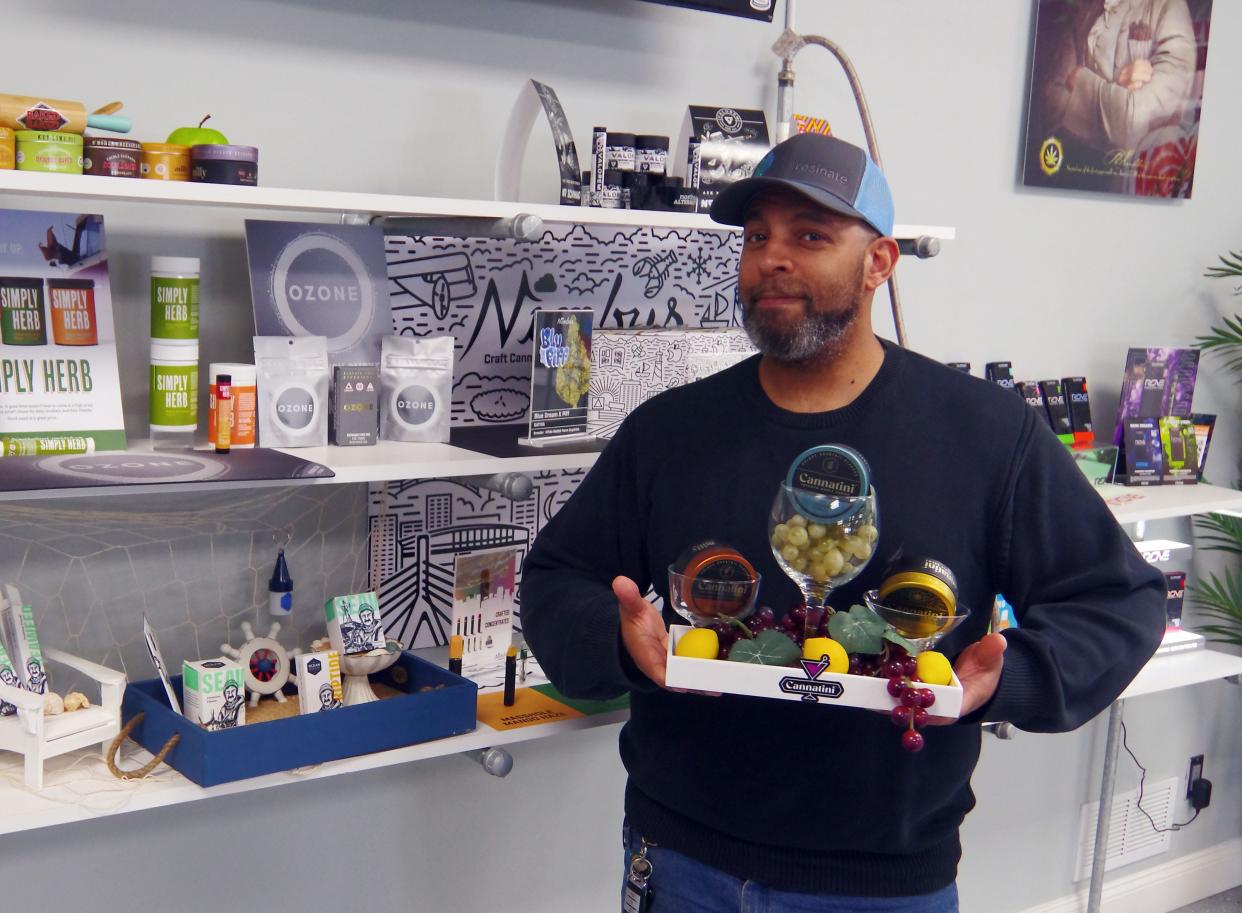 NAP Dispensary Manager Lary (only 1 L) Boyd stands with a display of various cannabis herb combinations in the retail location in Abington on Wednesday, April 17, 2024.