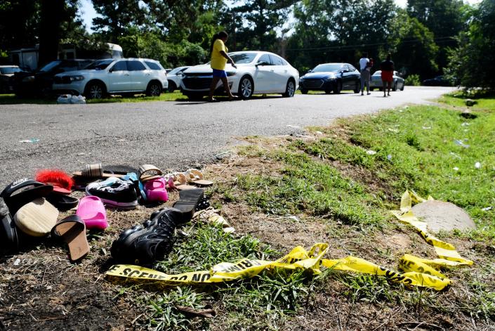 Crime scene tape and abandoned shoes discarded on Pearl Street Wednesday morning, July 5, 2023 in Shreveport which was the scene of a mass shooting that resulted in 4 deaths and 11 injuries.