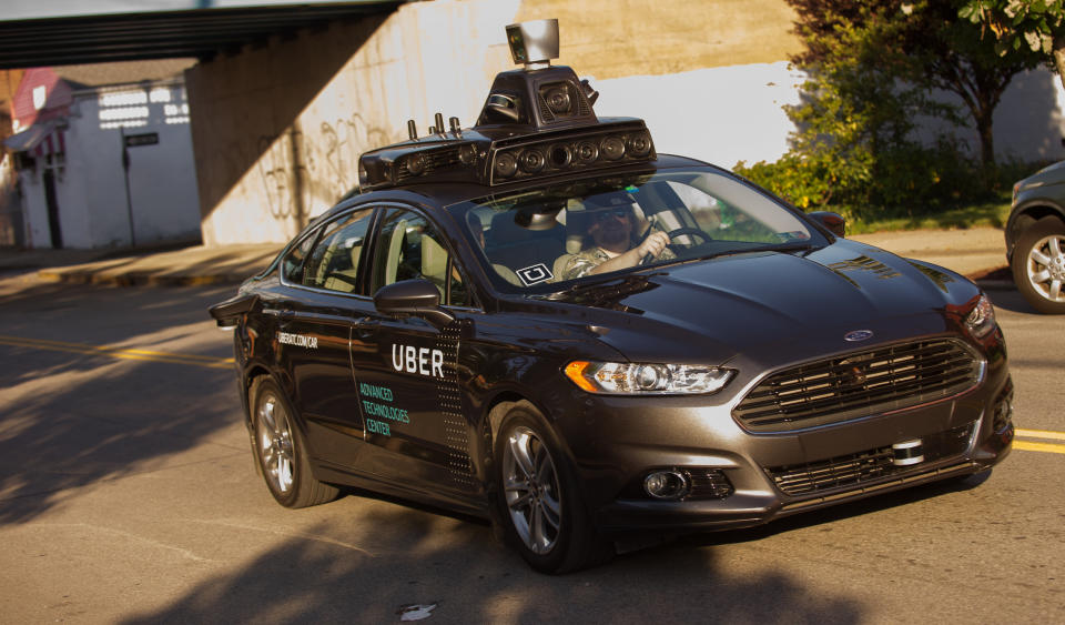 An Uber autonomous Ford Fusion drives through Pittsburgh in September 2016. The company, which now partners with Volvo, currently picks up and drops off riders from self-driving vehicles in only nine of Pittsburgh&rsquo;s 90 neighborhoods. (Photo: Jeff Swensen/Getty Images)