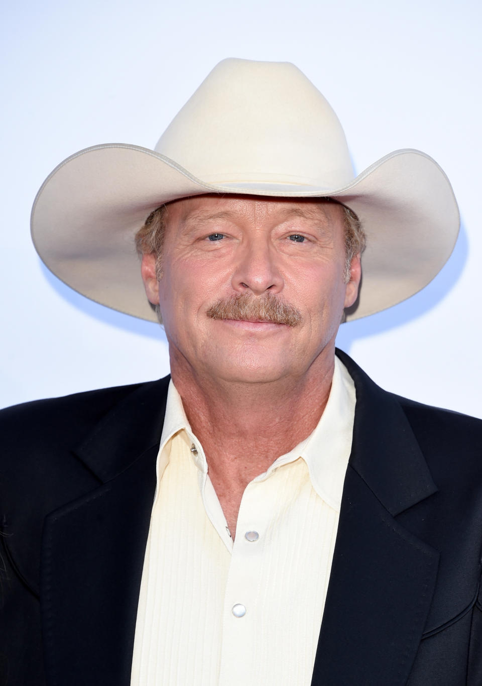 Alan Jackson says CMT, a degenerative condition that effects the muscles and nerves, has made performing difficult. (Image via Getty Images). 