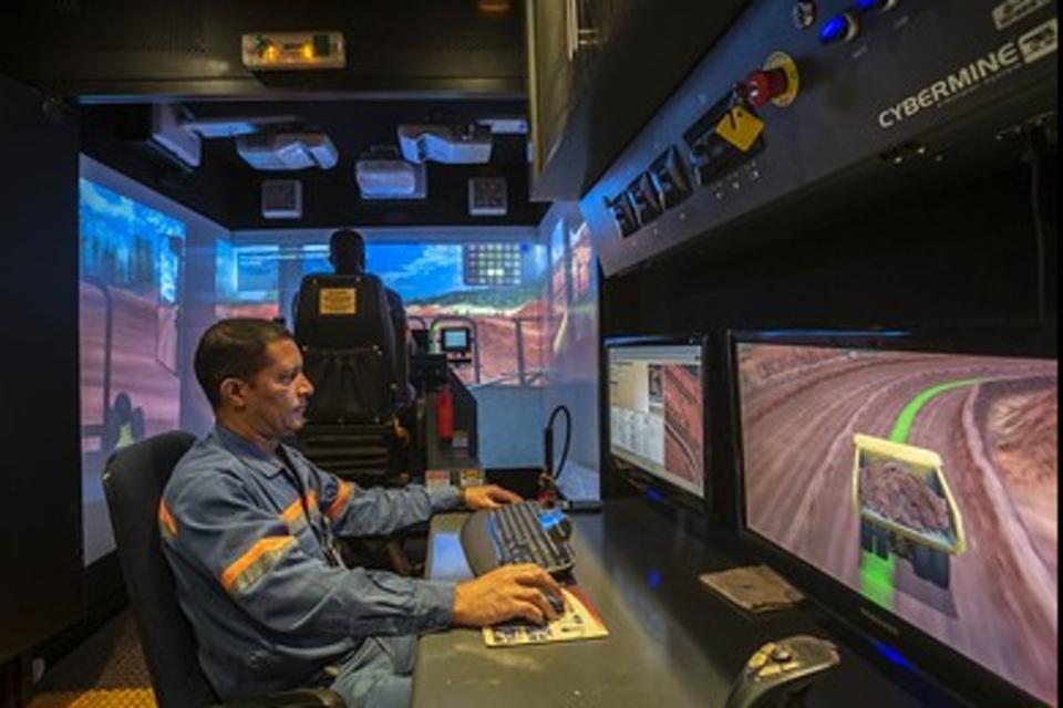 At Minas Rio, an equipment instructor examines data relating to the height definition training simulator featured in the background (Anglo American)