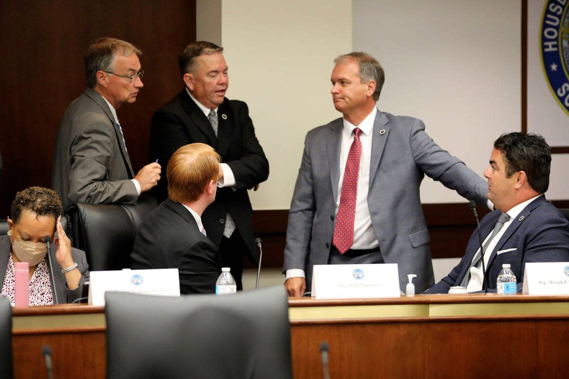 Several South Carolina House members confer during a break in a meeting of a special House committee looking at a stricter abortion law in the state on Tuesday, July 19, 2022, in Columbia, South Carolina. (AP Photo/Jeffrey Collins)