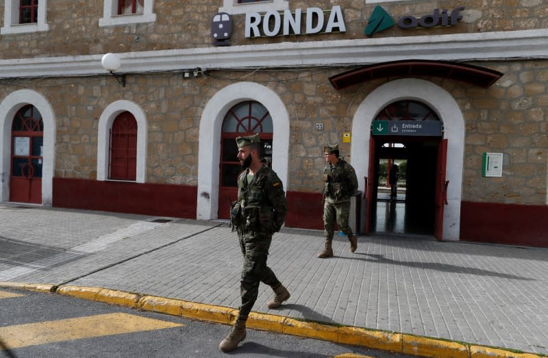 Spanish legionnaires patrol an empty train station in downtown Ronda