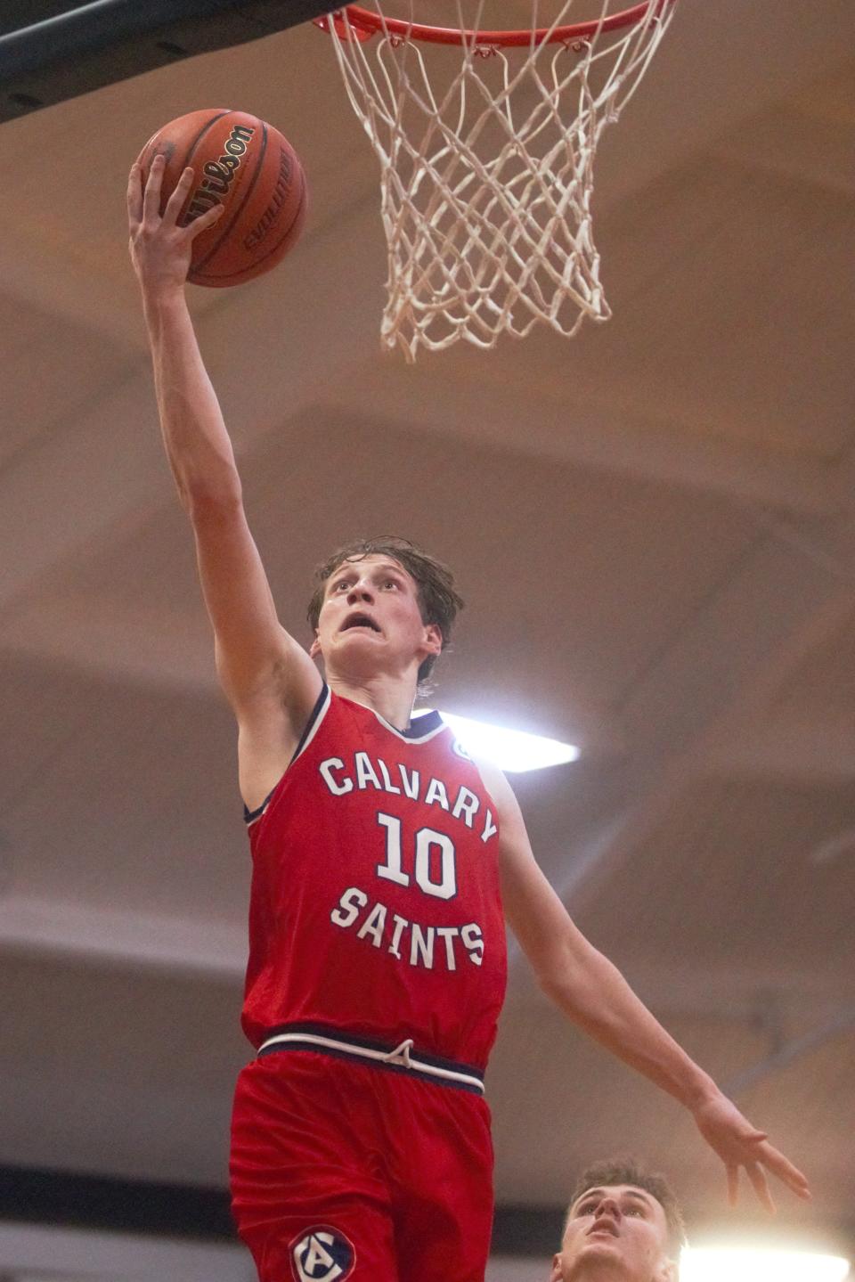 Calvary's Connor Brown goes up for a layup against New Berlin in the Class 1A New Berlin Regional semifinals at the Pretzel Dome on Wednesday, Feb. 21, 2024. Calvary won 61-48.