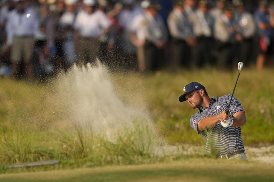 Bryson DeChambeau hits from the bunker on the 18th hole during the final round of the U.S. Open golf tournament Sunday, June 16, 2024, in Pinehurst, N.C. (AP Photo/Matt York)
