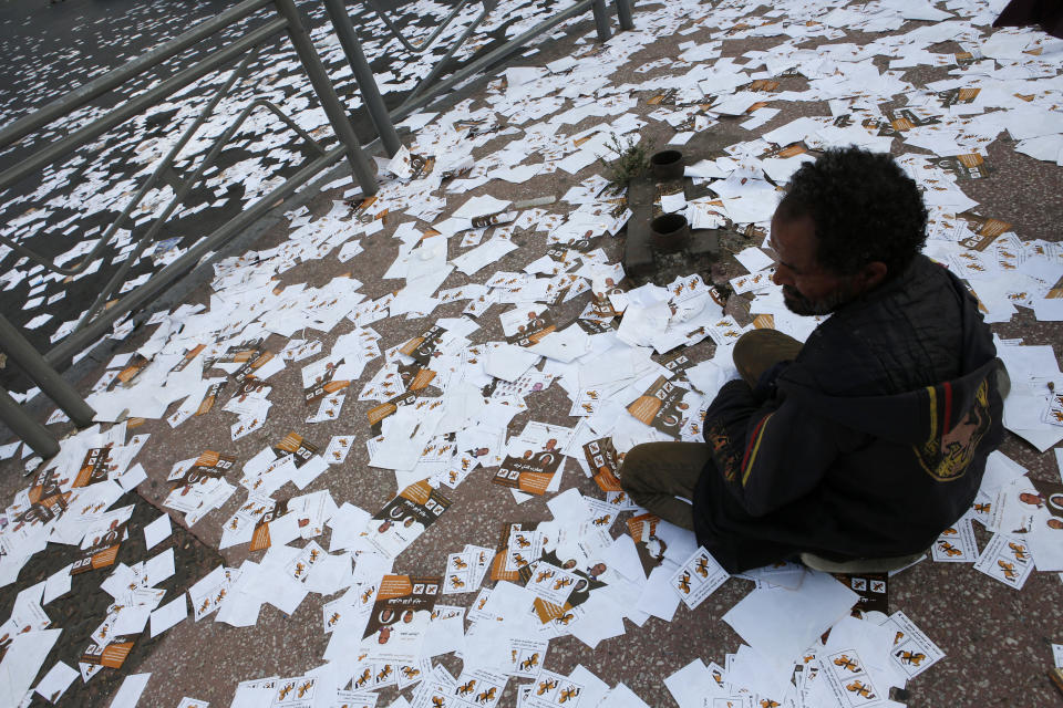 A man is surrounded by leaflets, following the passage of the supporters of a candidate during an electoral campaign in the place of Sraghna in the El Fida district in Casablanca, Monday Sept 6, 2021. The Election campaigns are often synonymous with the tossing of thousands of leaflets representing the symbol of the parties as well as the heads of candidate lists for electoral districts. Voting booths open on Sept. 8 for the North African kingdom's parliamentary elections, in which 395 seats in the upper house of Parliament are up for grabs. Communal and regional elections take place on the same day. (AP Photo/Abdeljalil Bounhar)