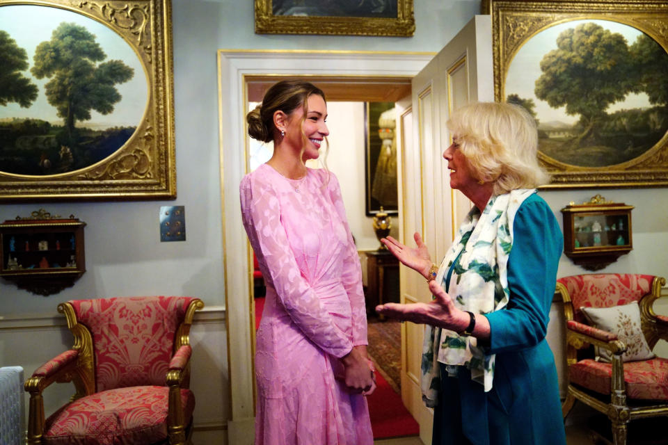 LONDON, ENGLAND - JANUARY 25: Camilla, Duchess of Cornwall talks with Zara McDermott, who has campaigned with Refuge to bring about a change in laws surrounding revenge porn, during a reception at Clarence House in London to mark 50 years of Refuge on January 25, 2022 in London, England. (Photo by Victoria Jones - WPA Pool/Getty Images)