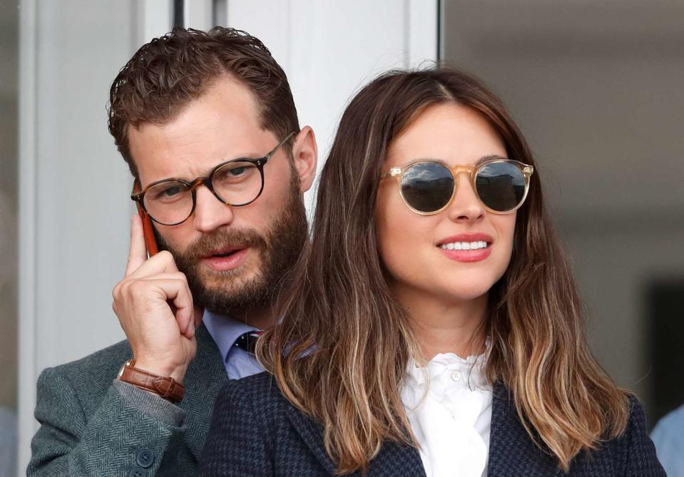 Jamie Dornan and Amelia Warner attend day 4 'Gold Cup Day' of the Cheltenham Festival at Cheltenham Racecourse on March 16, 2018 in Cheltenham, England