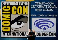 A woman takes a picture of a Comic-Con sign in San Diego, California United States, July 19, 2016. REUTERS/Mike Blake