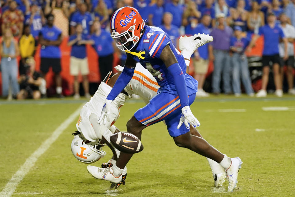 Florida safety Jordan Castell (14) breaks up a pass intended for Tennessee wide receiver Dont'e Thornton Jr., left, during the second half of an NCAA college football game, Saturday, Sept. 16, 2023, in Gainesville, Fla. (AP Photo/John Raoux)