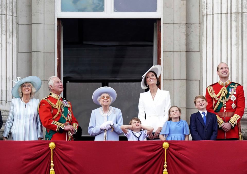 Prince Louis, center, is Not Amused by a flyover on June 2 during Platinum Jubilee celebrations. Camilla, the Duchess of Cornwall, Prince Charles, Queen Elizabeth II, Kate, Duchess of Cambridge, Prince Louis, Princess Charlotte, Prince George, and Prince William watch from the balcony of Buckingham Place after the Trooping the Color ceremony in London on the first of four days of celebrations to mark the monarch's 70 years of service. (Aaron Chown/Pool Photo via AP)