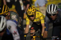 Denmark's Jonas Vingegaard, wearing the overall leader's yellow jersey, and Netherlands' Bauke Mollema, right, ride during the twenty-first stage of the Tour de France cycling race over 116 kilometers (72 miles) with start in Paris la Defense Arena and finish on the Champs Elysees in Paris, France, Sunday, July 24, 2022. (AP Photo/Daniel Cole)