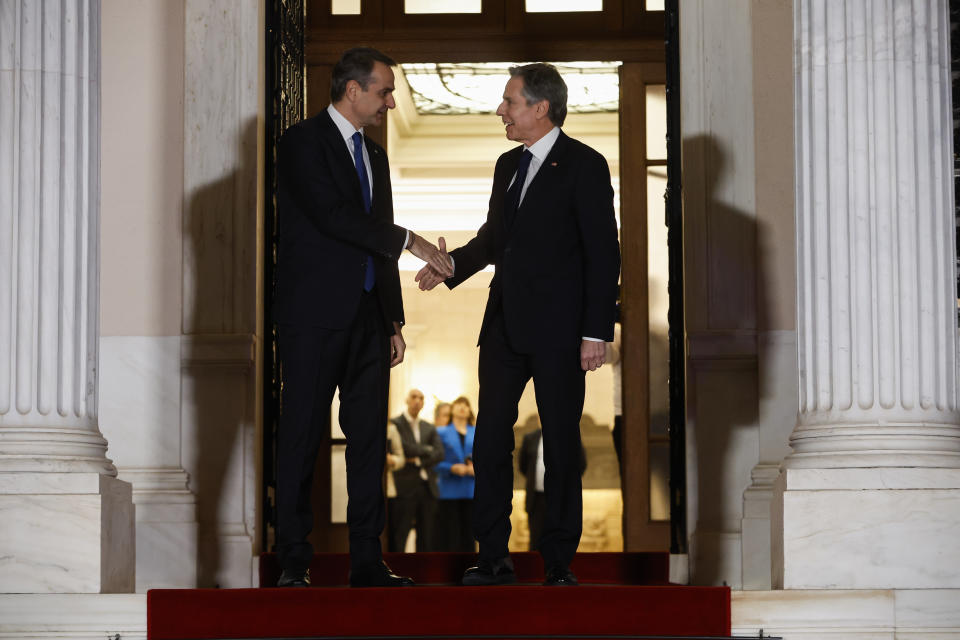 Greece's Prime Minister Kyriakos Mitsotakis, left, welcomes the US Secretary of State Antony Blinken before their meeting at Maximos Mansion in Athens, Greece, on Monday, Feb. 20, 2023. Blinken will be on a two-day trip in Athens, after his visit to Turkey, to meet with the country's leadership and launch the fourth round of the US-Greece Strategic Dialogue. (Louiza Vradi/Pool Photo via AP)