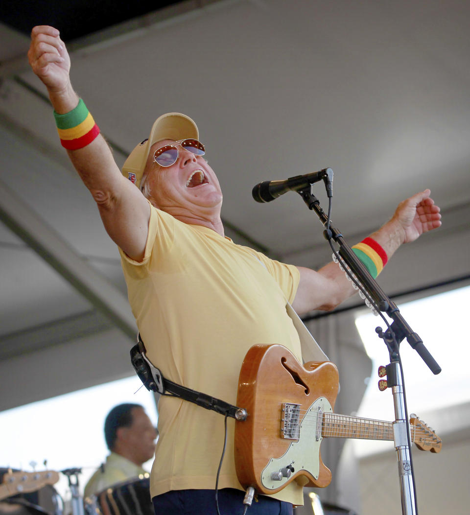 FILE - Jimmy Buffett & the Coral Reefer Band perform on the Acura Stage during the 2011 New Orleans Jazz & Heritage Festival on Saturday, May 7, 2011 at the New Orleans Fairgrounds. Buffett, who popularized beach bum soft rock with the escapist Caribbean-flavored song “Margaritaville” and turned that celebration of loafing into an empire of restaurants, resorts and frozen concoctions, has died, Friday, Sept. 1, 2023. (Rusty Costanza /The Times-Picayune/The New Orleans Advocate via AP)