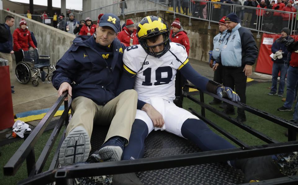 Michigan quarterback Brandon Peters is taken off the field on a cart during the second half of an NCAA college football game against the WisconsinSaturday, Nov. 18, 2017, in Madison, Wis. (AP Photo/Morry Gash)