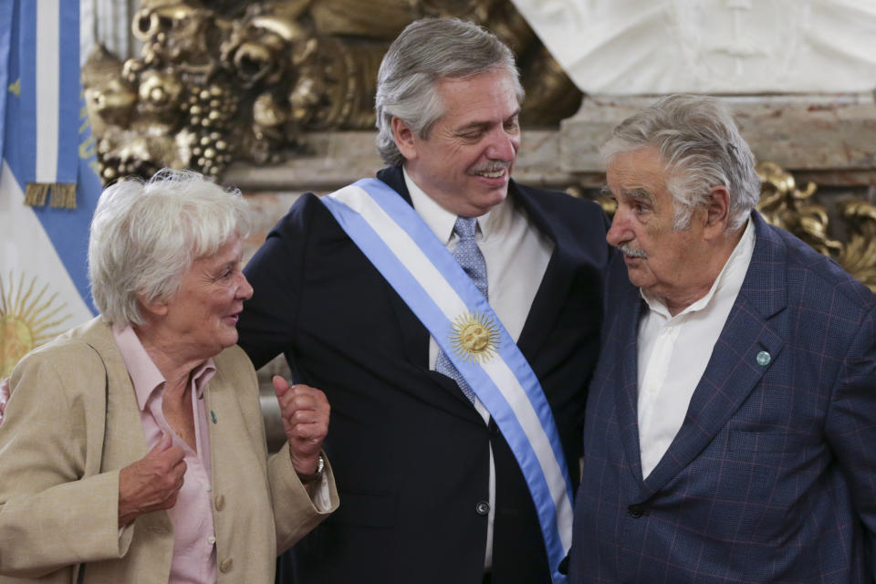 Argentina's President Alberto Fernandez ,center, greets former Uruguayan President Jose Mujica, right, and his wife Lucía Topolansky, at the presidential palace in Buenos Aires, Argentina, Tuesday, Dec. 10, 2019. Fernandez became president of Argentina on Tuesday, returning the country's Peronist political movement to power amid an economic crisis and rising poverty. (AP Photo/Daniel Jayo)