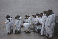 Paramilitary soliders stand on the banks near the site of a sunken ship in the Jianli section of Yangtze River, Hubei province, China, June 3, 2015. REUTERS/Aly Song