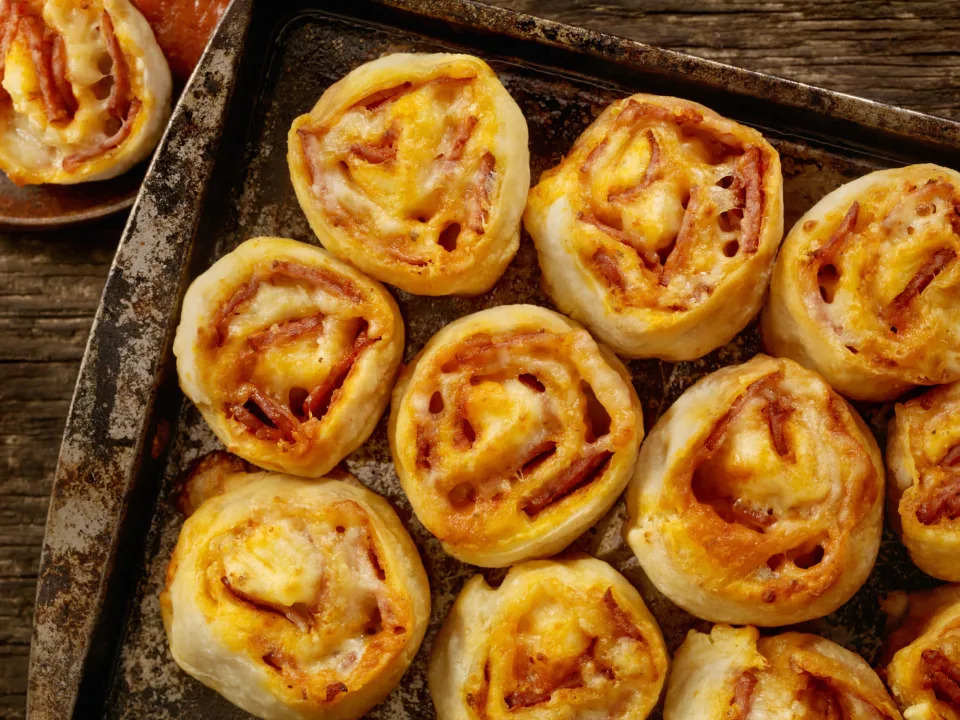 Pizza rolls on a baking sheet.