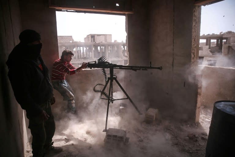 An opposition fighter fires a heavy machine gun in Jobar, a rebel-held district on the eastern outskirts of the Syrian capital Damascus, on March 19, 2017