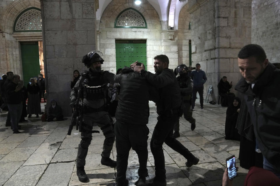 Israeli police detain a Palestinian worshipper at the Al-Aqsa Mosque compound in the Old City of Jerusalem during the Muslim holy month of Ramadan, Wednesday, April 5, 2023. Palestinian media reported police attacked Palestinian worshippers, raising fears of wider tension as Islamic and Jewish holidays overlap.(AP Photo/Mahmoud Illean)