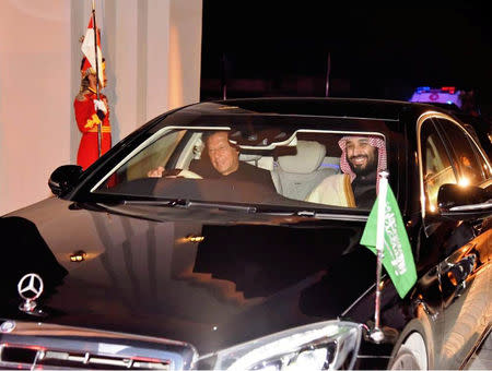 Pakistani Prime Minister Imran Khan (L) drives a vehicle as he receives Saudi Arabia's Crown Prince Mohammed bin Salman on his arrival at Pakistan Air Force (PAF) Nur Khan Base in Rawalpindi, Pakistan February 17, 2019. Press Information Department (PID)/Handout via REUTERS