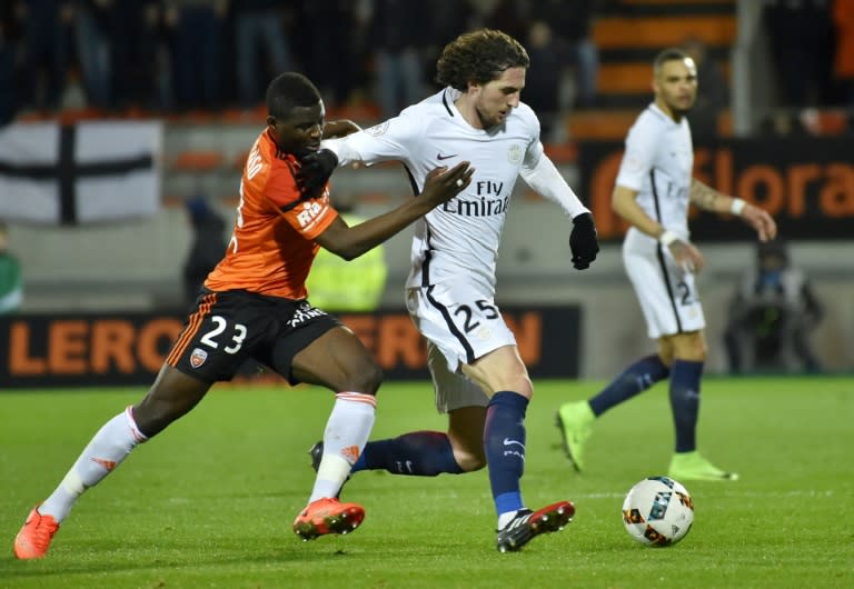 Lorient's defender Alhassan Wakaso (L) vies with Paris Saint-Germain's French midfielder Adrien Rabiot during the French L1 football match Lorient vs Paris SG at the Moustoir stadium in Lorient on March 12, 2017