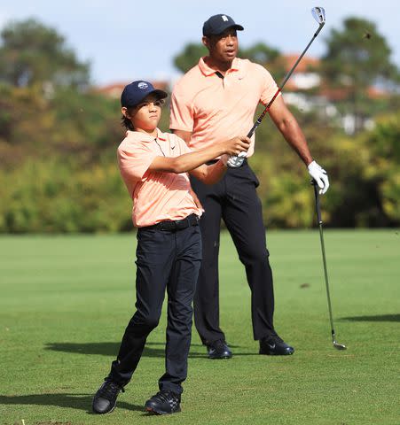 Sam Greenwood/Getty Charlie Woods plays a shot on the second hole as Tiger Woods looks on during round one of the PNC Championship at the Ritz Carlton Golf Club Grande Lakes on December 18, 2021 in Orlando, Florida.