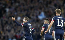 Scotland's Callum McGregor, left, celebrates after scoring his side's opening goal during the World Cup 2022 qualifying play-off soccer match between Scotland and Ukraine at Hampden Park stadium in Glasgow, Scotland, Wednesday, June 1, 2022. (AP Photo/Scott Heppell)