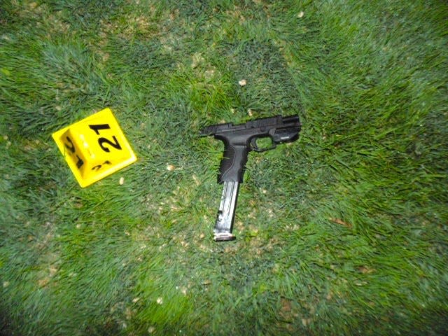 An evidence marker is positioned next to the 9 mm handgun Beau Wilson was firing when he was shot and killed by Farmington police on May 15, 2023.