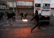 Protesters clash with police after a man, who was detained for violating social distancing rules, died from being repeatedly shocked with a stun gun by officers, according to authorities, in Bogota