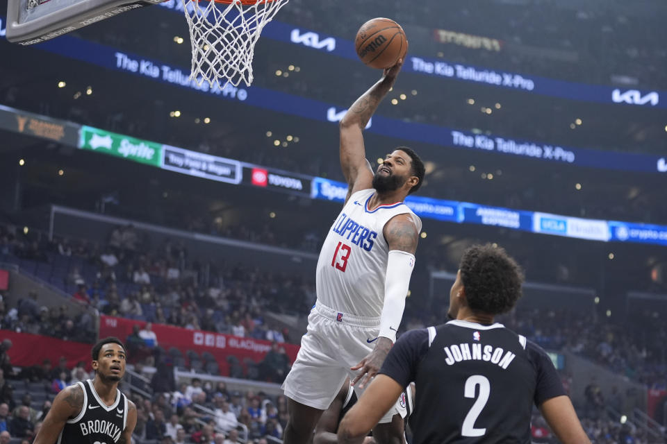 Los Angeles Clippers forward Paul George (13) drives to the basket against the Brooklyn Nets during the first half of an NBA basketball game Sunday, Jan. 21, 2024, in Los Angeles. (AP Photo/Marcio Jose Sanchez)