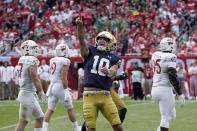 Notre Dame quarterback Drew Pyne celebrates his touchdown pass to wide receiver Kevin Austin Jr. during the second half of an NCAA college football game against Wisconsin Saturday, Sept. 25, 2021, in Chicago. Notre Dame won 41-13. (AP Photo/Charles Rex Arbogast)