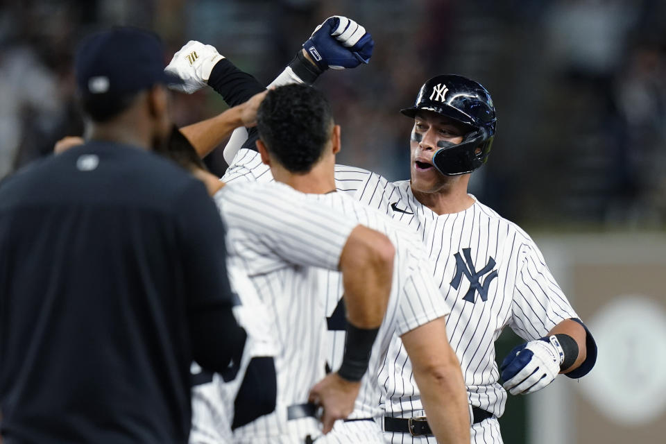 New York Yankees' Aaron Judge celebrates with teammates after hitting a single to drive in the winning run during the ninth inning of the team's baseball game against the Houston Astros on Thursday, June 23, 2022, in New York. The Yankees won 7-6. (AP Photo/Frank Franklin II)