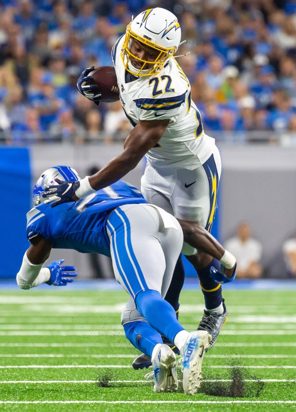 Chargers running back Justin Jackson falls forward for a first down against Lions safety Tracy Walker at Ford Field, Sunday, Sept. 15, 2019. The Lions beat the Chargers, 13-10.
