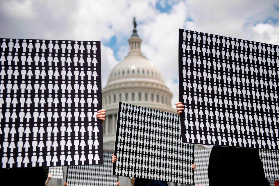 Demonstrators hold up placards representing the number of the people who have died due to gun violence on Capitol Hill in Washington, DC, on June 20, 2019, during an event with gun violence prevention advocates.