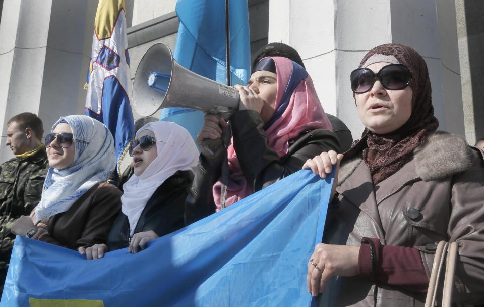 Pro-Ukrainian Crimean tartars protest against the Russian invasion in to the Ukrainian territory in front of Ukrainian parliament building in Kiev, Ukraine, Tuesday, March 11, 2014. Ukrainian Prime Minister Arseniy Yatsenyuk on Tuesday reiterated his call for Western nations to defend Ukraine against Russia.(AP Photo/Efrem Lukatsky)