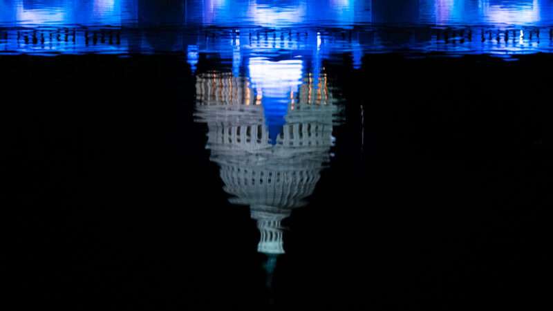 A photo of the U.S. capitol reflecting on water